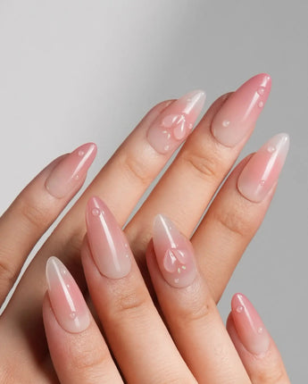 Peach Dew medium almond nails with soft peach glow and translucent fruit accents