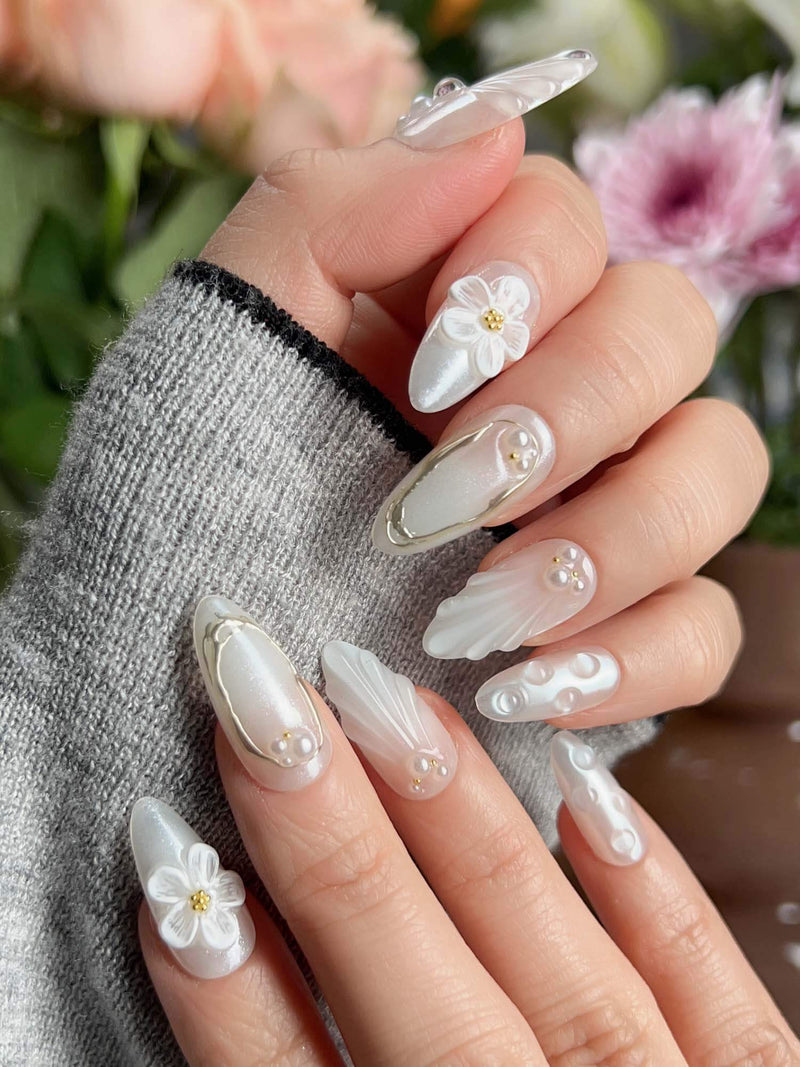 Pearl Bloom handmade press-on nails featuring pure white pearlescent base with 3D sculpted flowers and dewdrop shell textures