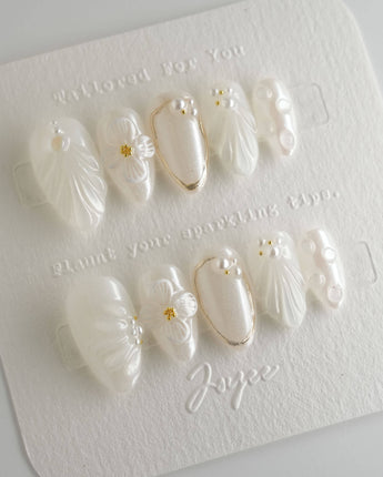 Pearl Bloom press-on nails in extra short almond shape — Pure White Pearlescent, 3D Flowers & Shell Texture.