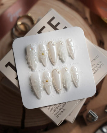Pearl Bloom press-on nails in medium stiletto shape — Pure White Pearlescent, 3D Flowers & Shell Texture.