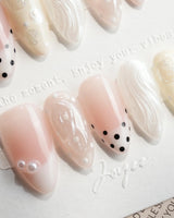 Pearl Dot short almond nails with nude pink base, pearl beads and shell shimmer