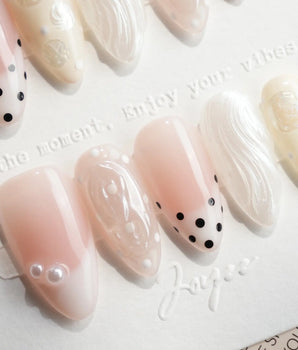 Pearl Dot short almond nails with nude pink base, pearl beads and shell shimmer