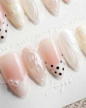 Pearl Dot short almond nails with nude pink base, pearl beads and shell shimmer