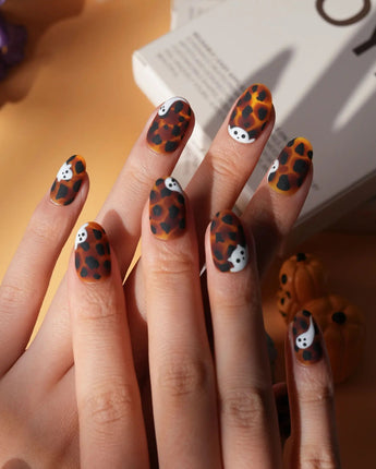 Peek-a-Boo press on nails with little white ghosts peeking out on a matte amber tortoiseshell base - image 3