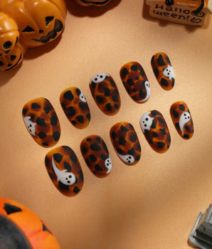 Peek-a-Boo press on nails with little white ghosts peeking out on a matte amber tortoiseshell base - image 2