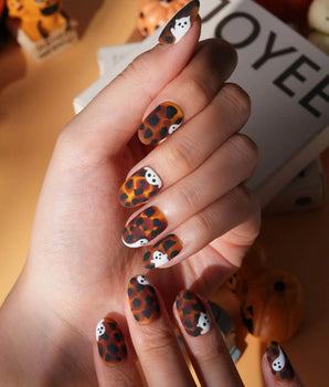 Peek-a-Boo press on nails with little white ghosts peeking out on a matte amber tortoiseshell base - image 1