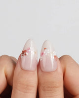 Petal Press press-on nails in medium almond shape — Warm Creamy Skin Tone, Hand-painted Florals & glitter Shimmer.