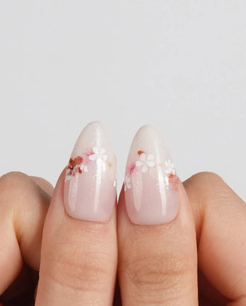Petal Press press-on nails in medium almond shape — Warm Creamy Skin Tone, Hand-painted Florals & glitter Shimmer.