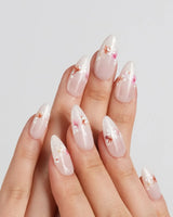 Petal Press nail art close-up showing Warm Creamy Skin Tone, Hand-painted Florals & glitter Shimmer. details
