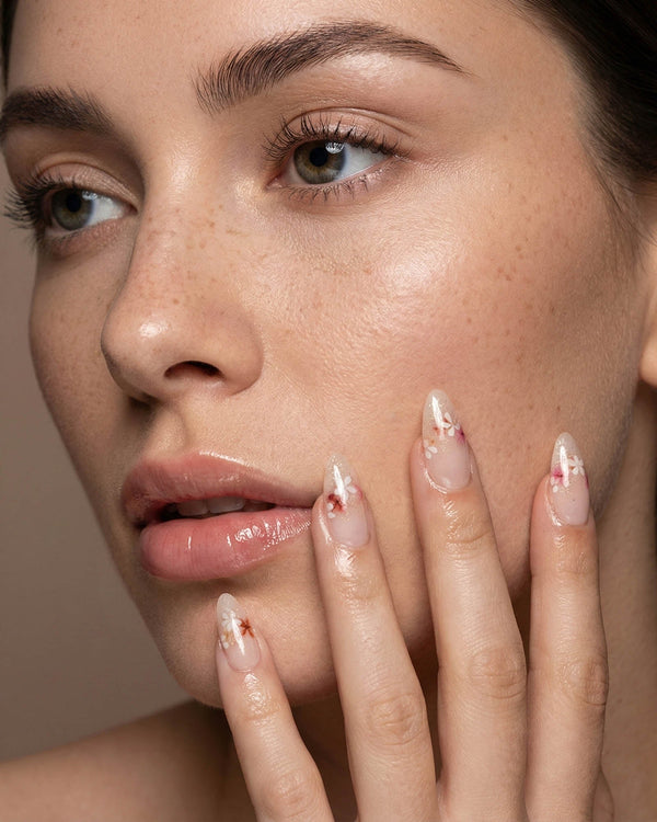 Petal Press handmade press-on nails featuring Warm Creamy Skin Tone, Hand-painted Florals & glitter Shimmer.
