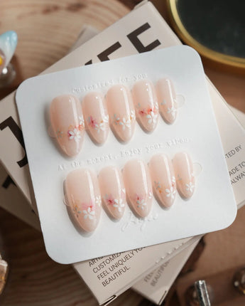 Petal Press press-on nails in medium almond shape — Warm Creamy Skin Tone, Hand-painted Florals & glitter Shimmer.
