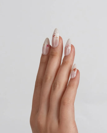 Petal Press press-on nails in extra short almond shape — Warm Creamy Skin Tone, Hand-painted Florals & glitter Shimmer.