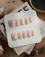 Petal Press press-on nails in extra short oval shape — Warm Creamy Skin Tone, Hand-painted Florals & glitter Shimmer.