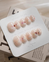 Petal Press press-on nails — Warm Creamy Skin Tone, Hand-painted Florals & glitter Shimmer. handmade nail art by Joyee Nails