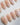 Petal Rain handmade press-on nails featuring nude, 3D White Butterfly Wings & Pastel Wildflowers.