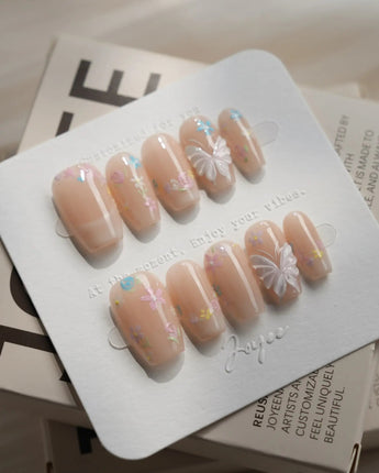 Petal Rain press-on nails — nude, 3D White Butterfly Wings & Pastel Wildflowers. handmade nail art by Joyee Nails