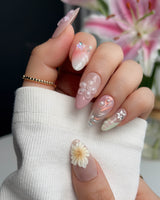 Wonderland Whims medium almond nails with soft pink base, 3D flowers, and tiny pearl accents