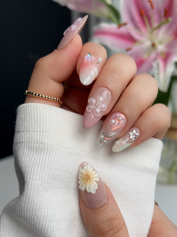 Wonderland Whims medium almond nails with soft pink base, 3D flowers, and tiny pearl accents