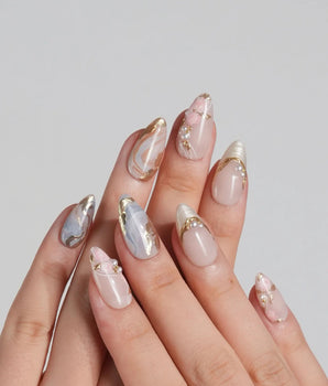 Vintage Mist press-on nails with soft marble texture, gold foil details and pearly accents