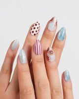 Pink Grapefruit icy blue press-on nails with brown polka dots and citrus details