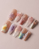 Wonderland Whims close-up of pink ombre floral nails with raised petals and pearl shine