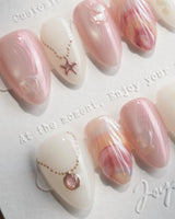 Pink Treasure extra short almond press-on nails with dusty rose marble and shell fragments