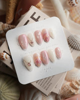 Pink Treasure extra short almond nails with silver jewelry charm accents