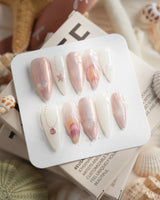Pink Treasure medium stiletto press-on nails with marble shell and jewelry details