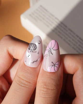 Pinkoween pink Halloween press on nails with pink pumpkins, a glitter ghost, silver bats and moons and holographic silver glitter nails - image 4