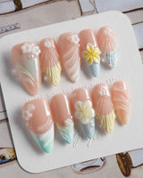 Plumeria-Island Breeze press-on nails in medium stiletto shape — Dreamy Macarons, 3D Plumeria & Shell Textures.