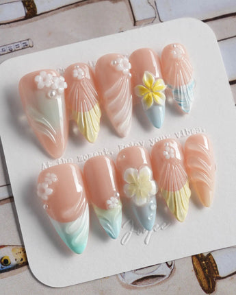 Plumeria-Island Breeze press-on nails in medium stiletto shape — Dreamy Macarons, 3D Plumeria & Shell Textures.