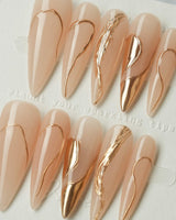 Poetic Glamour Nude press-on nails in long stiletto shape — nude french tip gold line