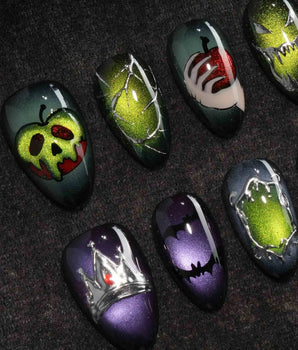 Poison Apple press on nails with a green skull poison apple, fanged grin, bat and 3D silver crown on green and purple cat eye - image 1