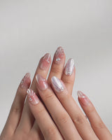Glow Shore video of nude pink shell and pearl press-on nails catching the light