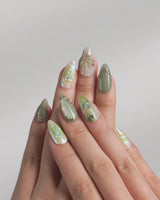 Dreamland video of green cat-eye press-on nails with 3D gold butterfly