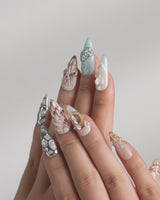 Coastline Edit video showing shimmering 3D shell and starfish press-on nails