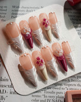 Duchess Purple long stiletto nails with lavender blossom sculpture and glossy magenta finish