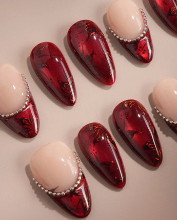 Brocade press-on nails with deep red carved texture, rose prints and silver accents
