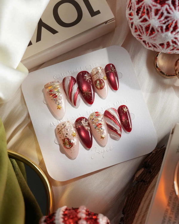 Red cat-eye Christmas press-on nails with glitter and ornament details