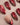 Red cat-eye press-on nails with gold shimmer