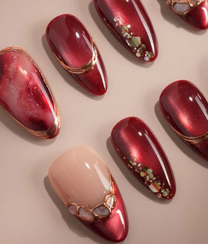 Molten Rouge handmade press-on nails featuring deep red cat eye nude base gold outline crystal accents