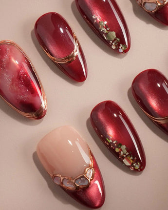 Molten Rouge handmade press-on nails featuring deep red cat eye nude base gold outline crystal accents