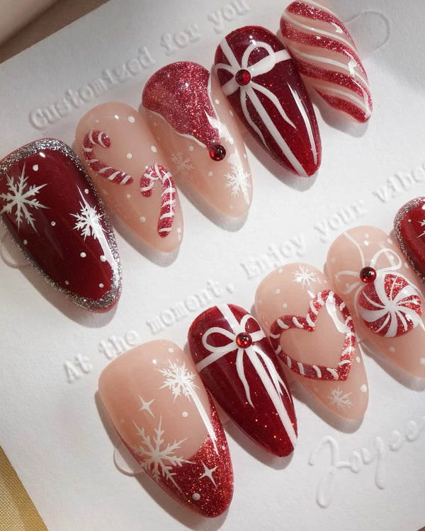Red Christmas press-on nails with candy cane and snowflake details