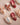 Red cat-eye nails with gold roses and 3D bow