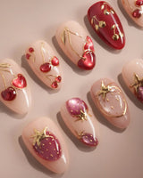 Crystal Berry press-on nails with nude base, red cat-eye cherries, gold outlines and glossy 3D accents