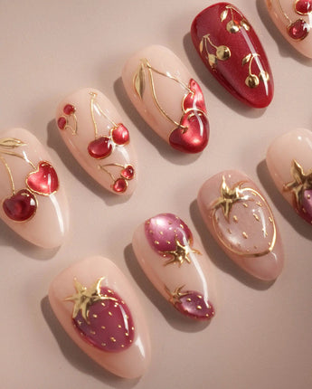 Crystal Berry handmade press-on nails featuring nude base red cat eye cherry gold outline 3D accents glossy finish
