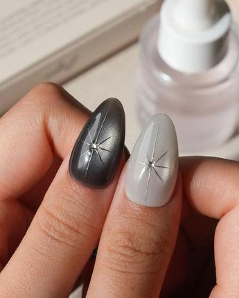 Relic press on nails in smoke grey and bone white with black marble veins, a silver starburst, a sculpted silver cross and a spiral - image 4