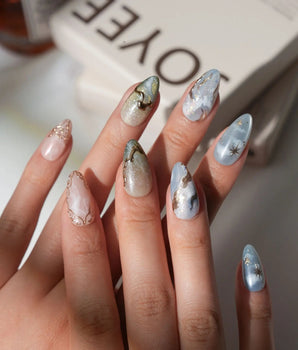Renaissance Fresco S press-on nails in short almond with sky blue clouds and stars