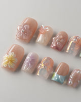 Wonderland Whims reusable custom floral nails with pink gel, flowers, and pearls