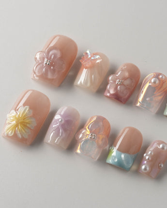 Wonderland Whims reusable custom floral nails with pink gel, flowers, and pearls